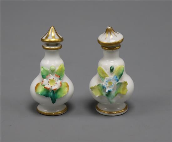 A pair of miniature floral encrusted scent bottles and stoppers height 6cm
